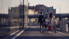 Two pedestrians – one male and one female wheeling a bike – walk together through central Gothenburg, home of Stena Metall Group. 