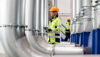 A female Stena Metall Group employee at work in a Stena facility wearing hi-vis protective gear.