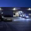 A forklift truck lifts palettes outside a Stena Stål facility in the evening.